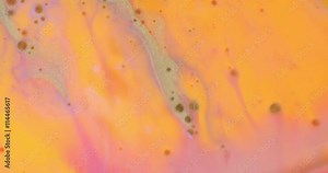 Color drop falling in water creating a Color spread. Colorful acrylic drop. Movement of paint in water. Water coloring.