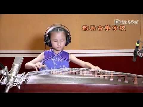 Chinese Kid of age 5+ playing Koto instrument