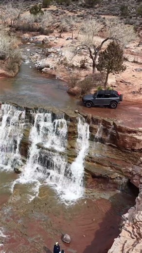 Driving through a waterfall at Toquerville Falls, Utah.