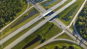 Time-lapse of freeway exit junction over road lanes with fast moving traffic cars and trucks. Interstate transportation infrastructure in USA