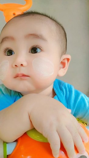 Infant Plays with Colorful Toy and Pacifier