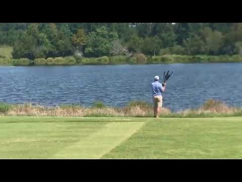 Guy throws golf clubs in the water