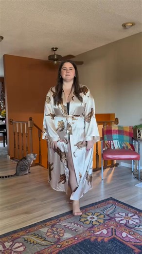 Wrap yourself in luxury with this plus-size leopard print satin bathrobe! The silky fabric, flattering belted waist, and chic kimono sleeves make it perfect for lounging, self-care, or relaxing in style any time of year. | Zavaro