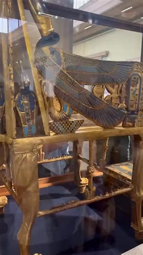 Read here ⬇ Behold the boy king’s throne. 🪑🫅The golden throne chair of King Tutankhamun. The chair is covered with snakes 🐍 all around it. The two snakes on the arm rest are unique since they have eagle wings.🦅 This mix of animals symbolized the king’s rulership over lower and upper Egypt. However, there are many hidden messages in the design of the throne chair. We will explain it in full detail when we tour the Grand Egyptian Museum In February and October of 2026! For more details, please