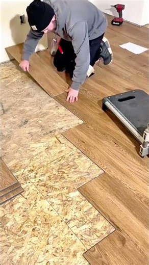 cutting wood patterned laminate flooring to fit and installing the pieces on an oriented strand