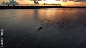 Epic footage of Amazon River in Peru Incredible sunset, traditional boat with people on river. Beautiful View of Amazon Rainforest and River. Peru. Drone footage 4K.