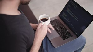Free Video Stock Software Developer Holding A Coffee Cup Live Wallpaper | DesktopHut