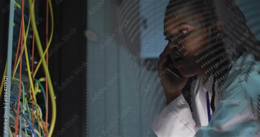 Woman tech taking call and checking network rack, fixing ports while overlay sweeping across face