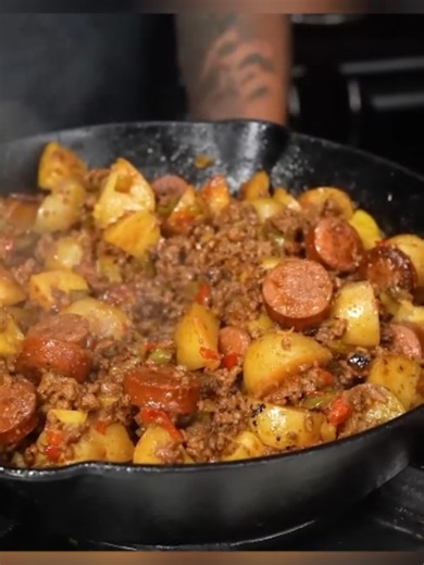 Y’all, these Dirty Smothered Potatoes are calling your name! This is the kind of comfort food you make room for on your plate. What are you serving with yours? Get the full recipe at smokinandgrillinwitab.com. #SmokinAndGrillinWithAB #DirtySmotheredPotatoes #SmotheredPotatoes #SouthernCooking #ComfortFood