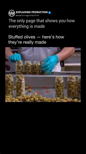 Explaining Production on Instagram: "The perception that stuffed olives are prepared manually is often held; however, they are, in fact, the product of a remarkably precise industrial process. Following harvest, olives undergo a curing process in brine to eliminate their inherent bitterness. Subsequently, they are processed by high-speed pitting machinery that extracts the pit without compromising the integrity of the fruit. Immediately thereafter, specialized nozzles inject various fillings, su