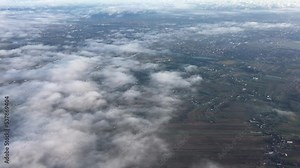 View from the airplane window. Airplane wing with landscapes of forests, trees, clouds, sky, city, fields and nature. View from above airplane landscape. Nature landscape from flying plane.