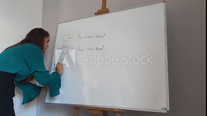 Woman teaches geometry formulas on a whiteboard in a classroom setting