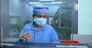 worker packing medicines. tablets capsule pill packing machine in aluminum strips. packed medicine inspection packs moving on conveyor belt. medicine packing line, workers checking for quality control
