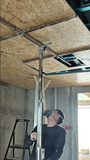 installing plywood ceiling panels using a metal jack for professional house construction activity