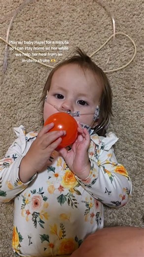 Hazels Heroes Homebase on Instagram: "UPDATE 09/26/25: Hazel is on .5 liters of oxygen & is on 24hr feeds through her feeding tube. Hazel ate 24 bites of yogurt today, so she got to take a full hour off from her feeding pump! She also had no appts/therapies today, so we got to spend some quality time w/ each other & friends. We have a lot of appts next week, so please pray for good news & continued progress in helping Hazel heal 🩷 #baby #rare #reels #cute #healing"