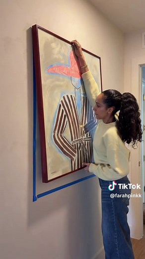 Easiest way to hang artwork by yourself 👏 use blue tape to map it out, mark the nail spot, and hang with a deco hook.. no extra tools needed! #diyhome #hometips #wallart #homedecorideas