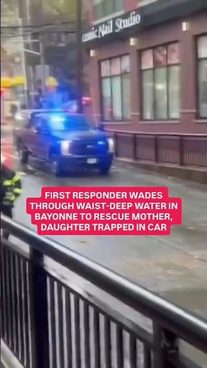 First responder wades through waist-deep water in Bayonne