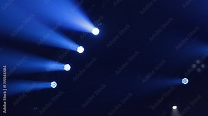 An empty stage of the theater, lit by spotlights and smoke before the performance