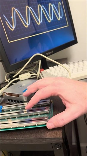 Three potentiometer sliders connected to the computer, controlling different inputs.