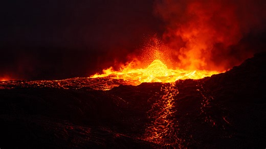 Fiery volcano eruption at night