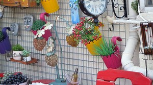 Vintage outdoor decor featuring colorful planters and wall art adds a vibrant touch to the space