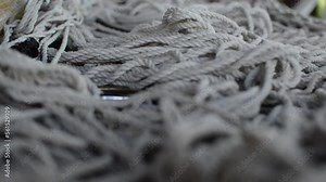 white bondage rope on a leather table. bdsm rope for bondage sex.