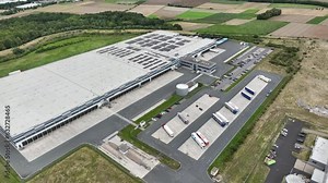 Loading bay, truck parking lot, industrial building, logistics - aerial view - tracking shot