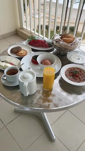 Cozy Beachside Breakfast Setup on a Scenic Balcony