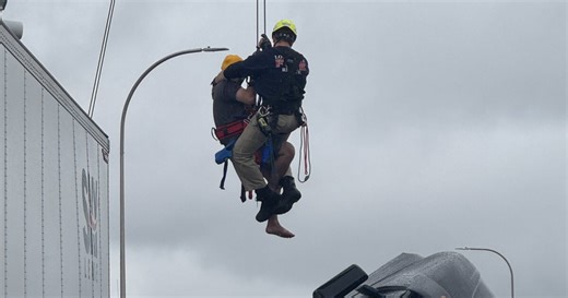 Semi-truck driver rescued after dangling over Kennedy bridge in Louisville