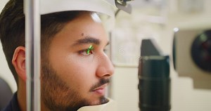 Closeup of a Slit Lamp Machine Testing Eye and Pupil Reflexes of a Male Patient during an Optician Consult. Headshot of Stock Video - Video of optometrist, optician: 251671019