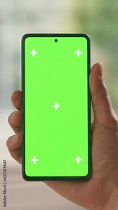 Vertical Screen: POV View of a Manager Holding a Smartphone with Green Screen Mock Up Display. First Person View of a Man Holding a Device with Isolated Area for Apps, Website Design Promotions