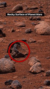 Rocky Surface of Planet Mars The surface of Mars is extremely rocky, dusty, and rugged. It is covered with volcanic rocks, ancient lava plains, sharp stones, and fine red dust. This red color comes from iron oxide (rust) in the soil, which is why Mars is called the Red Planet. Scientists have found evidence of ancient water activity, such as dried river channels, layered rocks, and cracked surfaces. These rocks preserve clues about Mars’s volcanic history, past climate, and the possibility of an