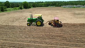 Planting Bermuda grass with the John Deere 4320 #johndeere #farmtok #fyp #tractor #4320 #farmlife #farming #planting #grass #plantingseason #farmlifeisthebestlife #oklahoma #drone #dji #haybuster