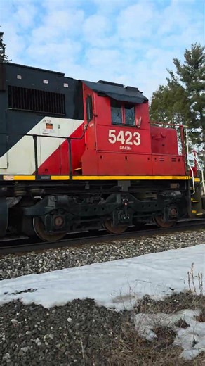 CN 5423 pulls an Eastbound local center beam flat car freight train at Vicksburg, MI