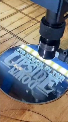 Engraving “sorry I can’t. I’m stuck in the upside down” on glass.