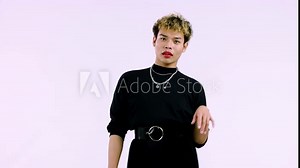 young gay man acting isolated pink color background. LGBTQ+ pride month concept, 4k video footage