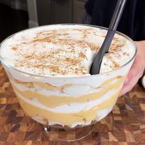 Ingredients List: - 24 oz angel food cake - 16 oz whipped or regular cream cheese (softened) - 15 oz pure pumpkin - 3/4 cup brown sugar - 2 tsp vanilla extract - 3 tsp pumpkin spice mix (plus extra for sprinkling on top) - 16 oz Cool Whip Directions: - Chop the angel food cake into bite-sized pieces and place 1/3 of it into the trifle bowl. - In a separate mixing bowl, whisk or blend the cream cheese. Then, add the pure pumpkin, brown sugar, vanilla extract, and pumpkin spice. Mix until smooth. 