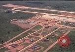 May 1965 – Thailand: Aerial views of Korat Air Base, Thailand. F-105D aircraft parked on ramp. Fuel tank storage area. Flight line and surroundings