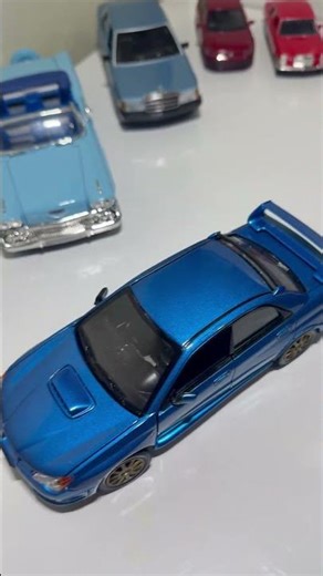 Iconic Subaru Impreza WRX STI (GDB) Diecast Model - World Rally Blue with Gold Wheels