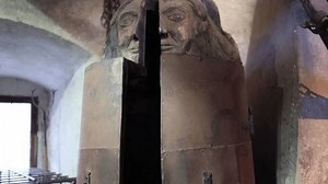 An iron maiden, a notorious medieval torture device, stands ominously in a dimly lit room. Its menacing design symbolizes the harsh and brutal punishments of the past.