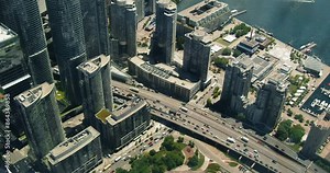 This video presents a panoramic view Toronto from a bird's-eye perspective, where skyscrapers create an impressive sight.Central areas city display their architectural beauty, combining modern designs