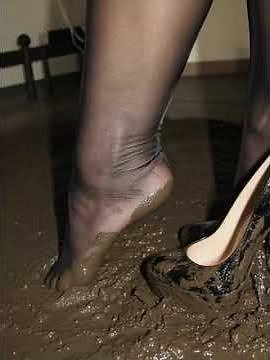 Black high heels in the mud