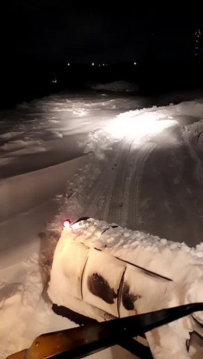 Snowplow in Action: Nighttime Snow Clearing