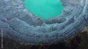 View from above, stunning aerial view of the Ijen volcano with the turquoise-coloured acidic crater lake. The Ijen volcano complex is a group of composite volcanoes located in East Java, Indonesia.