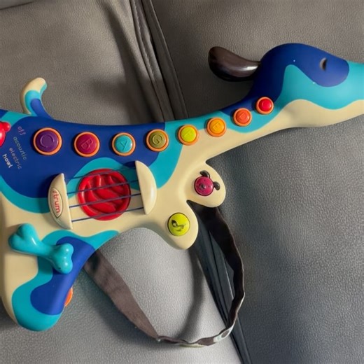 Toys Bay on Instagram: "B. toys Woofer Hound Dog Guitar, an interactive musical toy for children. Multiple sound modes: Acoustic, electric, and “howl” (dog sounds). Pre-loaded music: Contains 20 nursery rhymes and 9 dog-themed songs. Interactive buttons: Features 8 music buttons, a strum area, and a “whammy bone” for sound effects. Volume control: Allows adjusting the sound level. Kid-friendly design: Lightweight and easy for small hands to hold. ✅Price; 250Ghc"