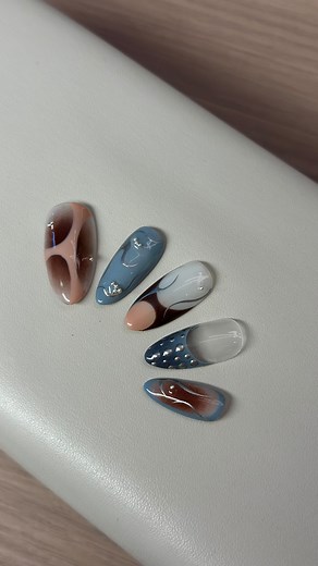 Olyv Nail and Beauty bar on Instagram: "nails-on-the-go Season 2 ep. 7 🎨💅🏼 Swirls, dots & glossy vibes 💫🌀✨ Living that mix-n-match mani life 💙🤎🤍 #NailGoals #ArtOnFleek #NailArt #SwirlNails #IndieNails #NailInspo #MixAndMatchNails #TrendyNails #NailDesigns #AestheticNails #GlossyNails #NailDetails #NailGoals #NailAddict #AbstractNails #NailTrends2025 #NailVibes"