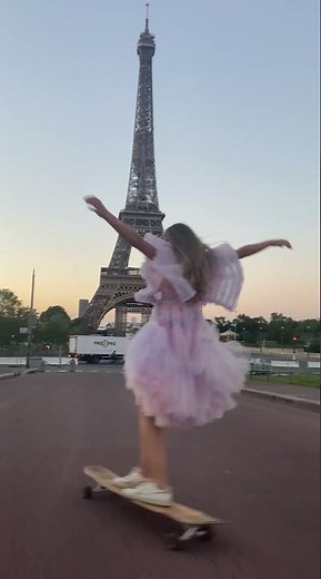Girl Longboards on Streets of Paris While Wearing a Beautiful Dress During Sunrise