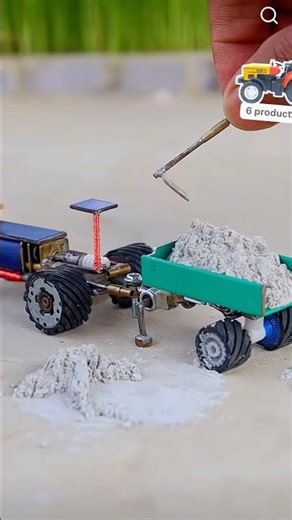 Sand is being loaded onto a mini _truck using shovels and transported away.#tractor