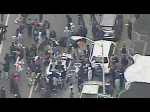 Demonstrators attack police car