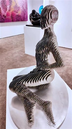 Now you see me, now you don’t. This striking stainless steel sculpture by Julian Voss-Andreae (@julianvossandreae), presented by HOFA Gallery (@thehouseoffineart) at Art Miami (@artmiamifairs) 2025, transforms with every step the viewer takes. From certain angles, the figure appears solid and grounded. Viewed directly from the front or back, it nearly disappears, dissolving into space. December, 2025. Voss-Andreae is a German sculptor based in Portland, Oregon, known for large-scale public and p